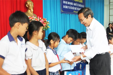 Ông Lê Minh Tùng, Phó Ban Dân vận Tỉnh ủy và ông Phan Văn Hà, Chủ tịch Hội Bảo trợ bệnh nhân nghèo, Người khuyết tật và Trẻ mồ côi tỉnh trao học bổng.