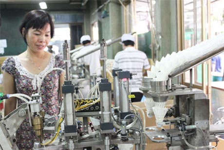 Chị Hồng Thúy đang kiểm tra máy dán keo.