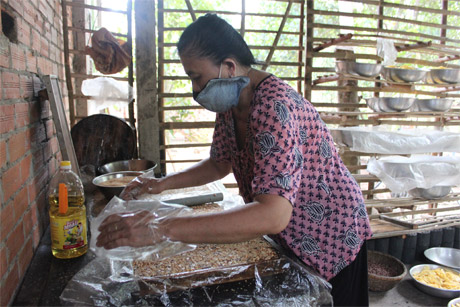 Bà Tám Vui đang ép mứt khóm vào khuôn.