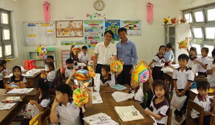 Anh Trần Minh Thanh (người đứng bên phải) trong 1 lần tặng quà trung thu cho trẻ em  nghèo ở huyện Tân Phú Đông.  