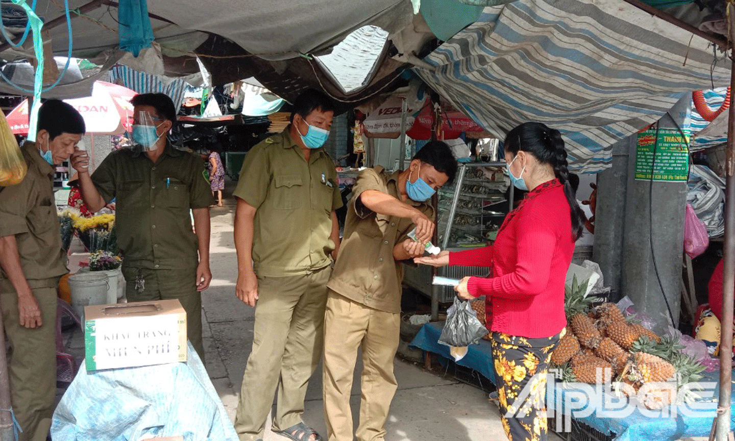 Người dân được đo thân nhiệt, rửa tay sát khuẩn khi vào chợ Hậu Thành,