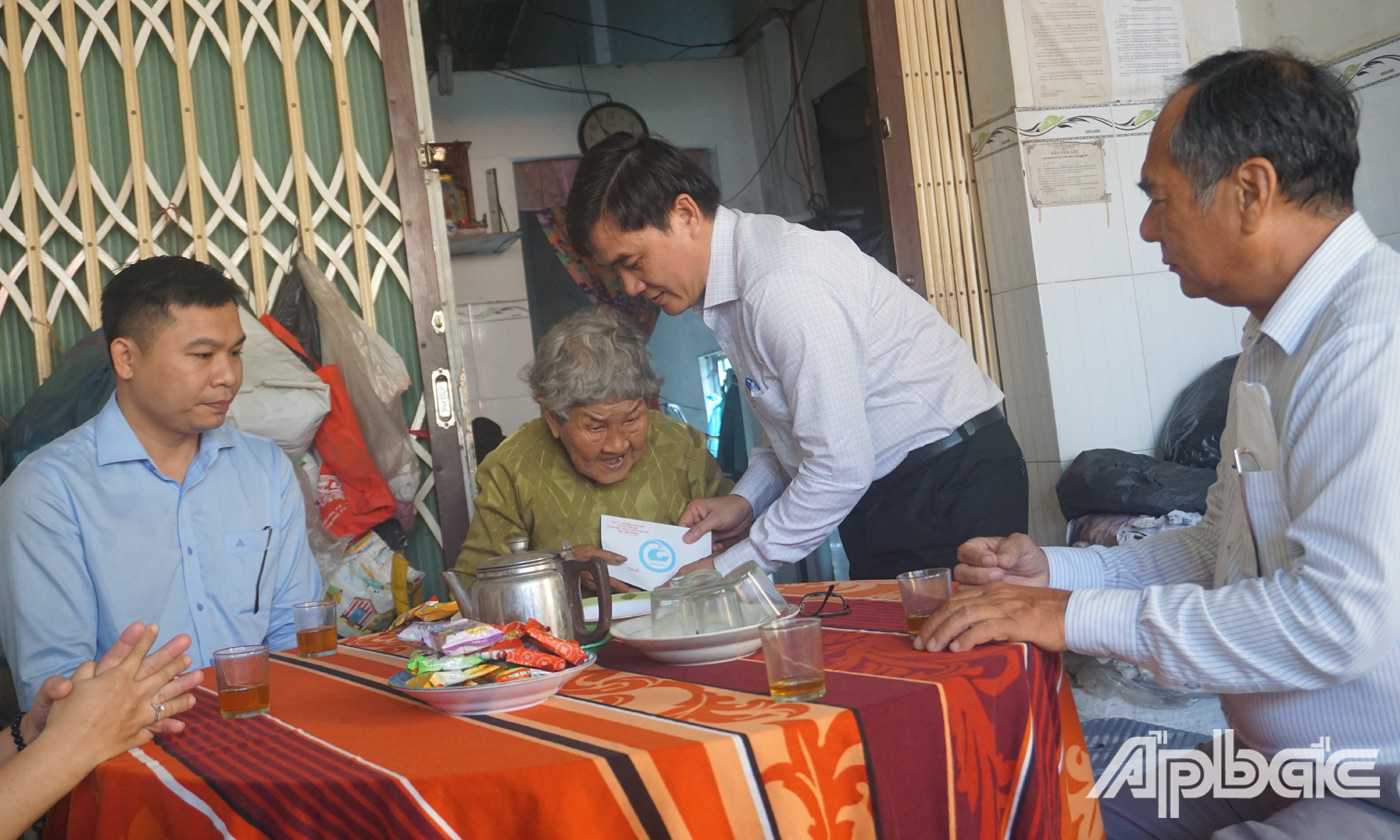 Đồng chí Nguyễn văn Mười và các thành viên trong đoàn đến thăm và tặng quà bà Nguyễn Thị Cúc, mẹ liệt sĩ, ấp 1, xã Long Trung.