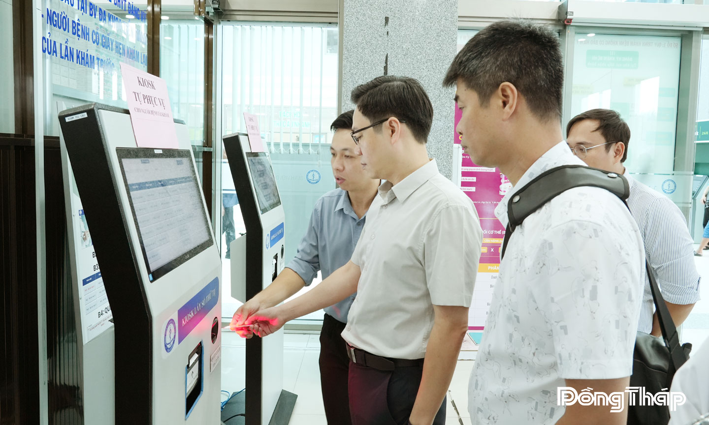 Ông Nguyễn Bá Hùng(đứng giữa), đi kiểm tra thực tế chuyển đổi số tại bệnh viện.