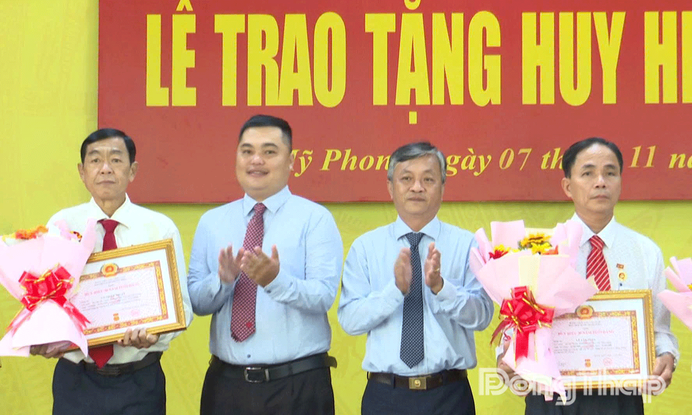 Đảng ủy phường Mỹ Phong trao Huy hiệu Đảng cho các đảng viên.